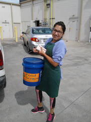coffee shop client holding compost business collection bucket